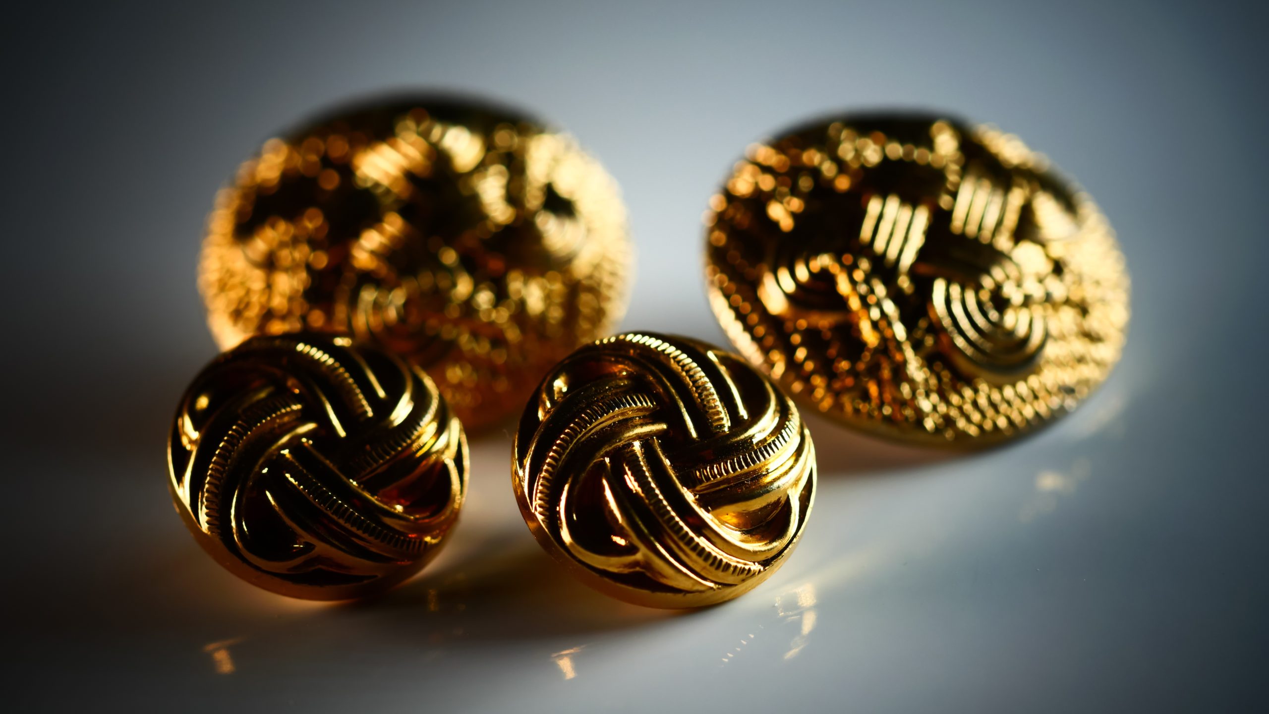 Golden decorative buttons symbolizing luxury and artisanal craftsmanship in Bella Krystal’s Quinceañera dress designs.